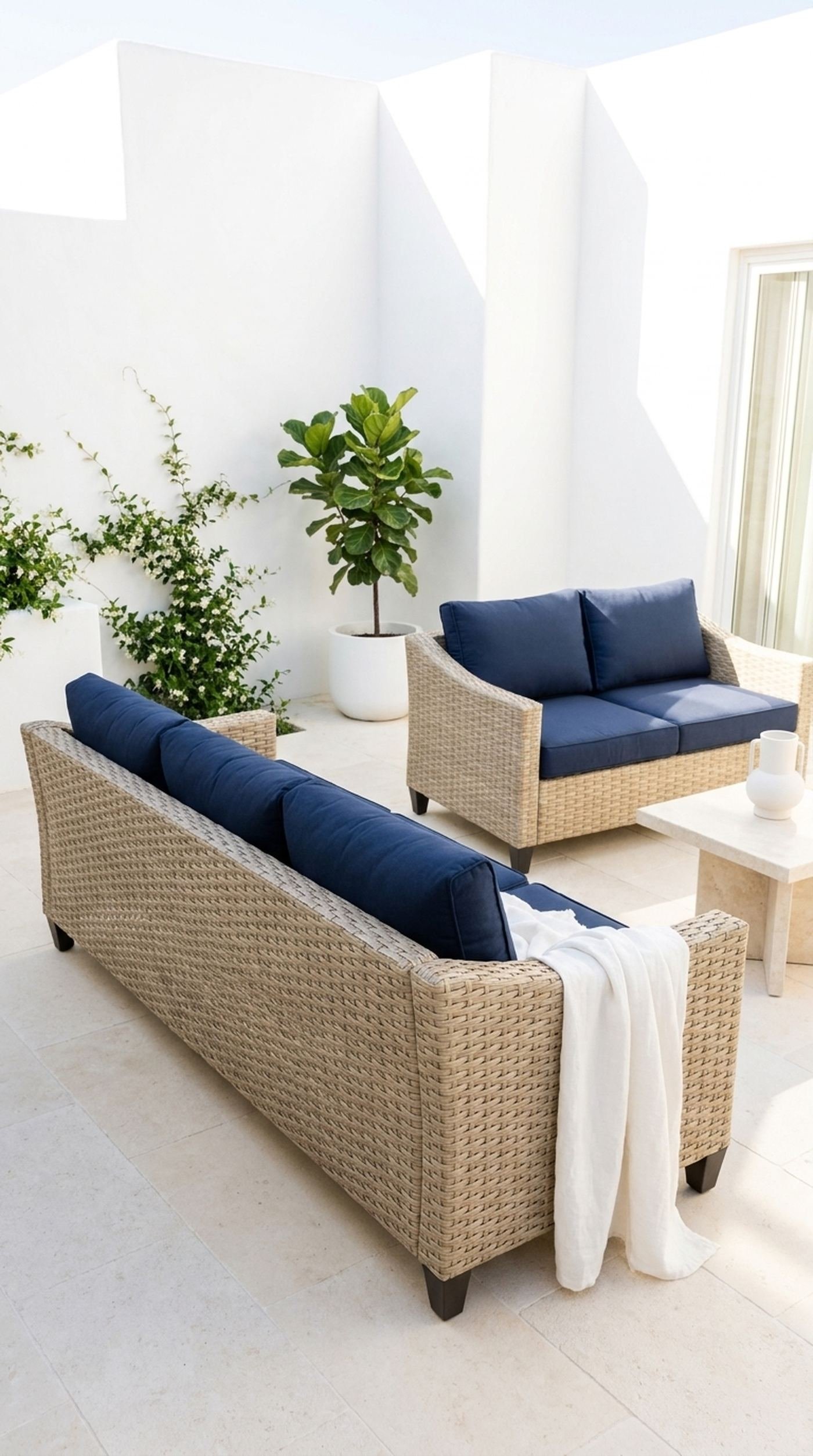 Woven outdoor seating with navy cushions